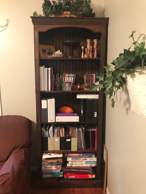 homeschool bookshelf with textbooks, games, and school supplies